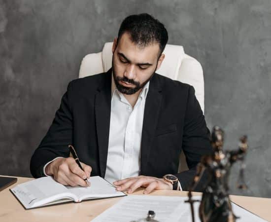 man sitting down, writing in diary