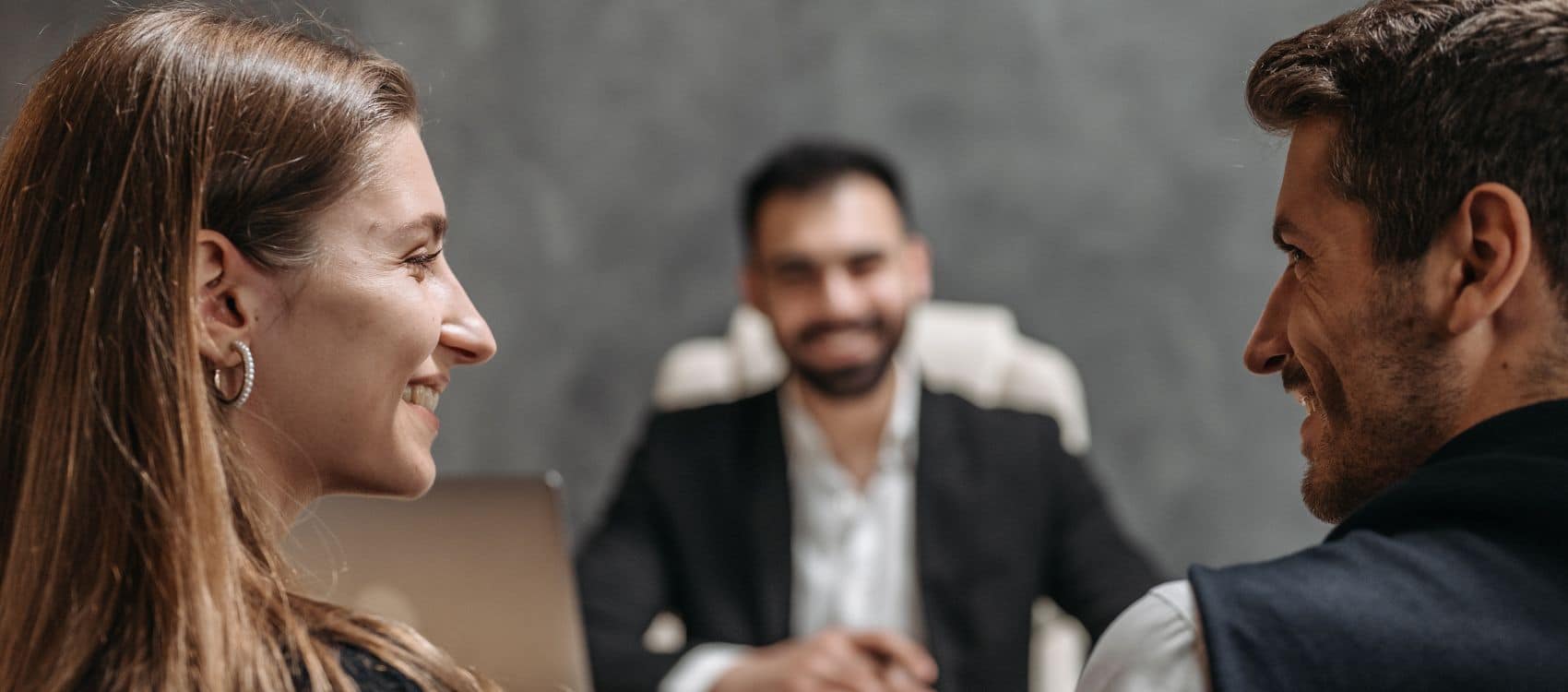 two men and a woman conversing